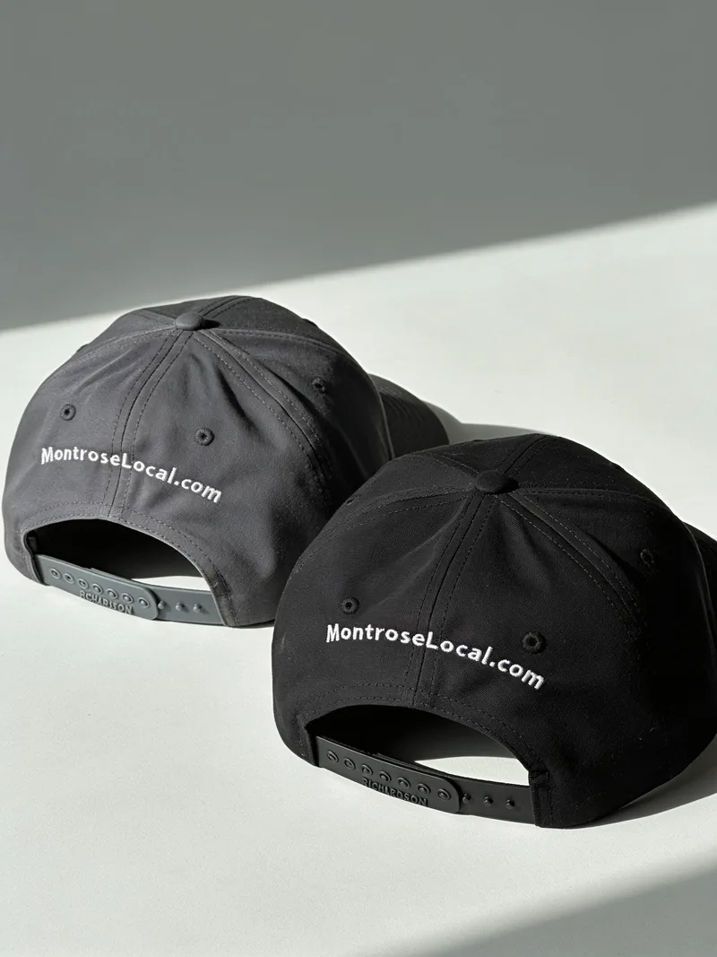 Two black caps with MontroseLocal.com embroidered across the back