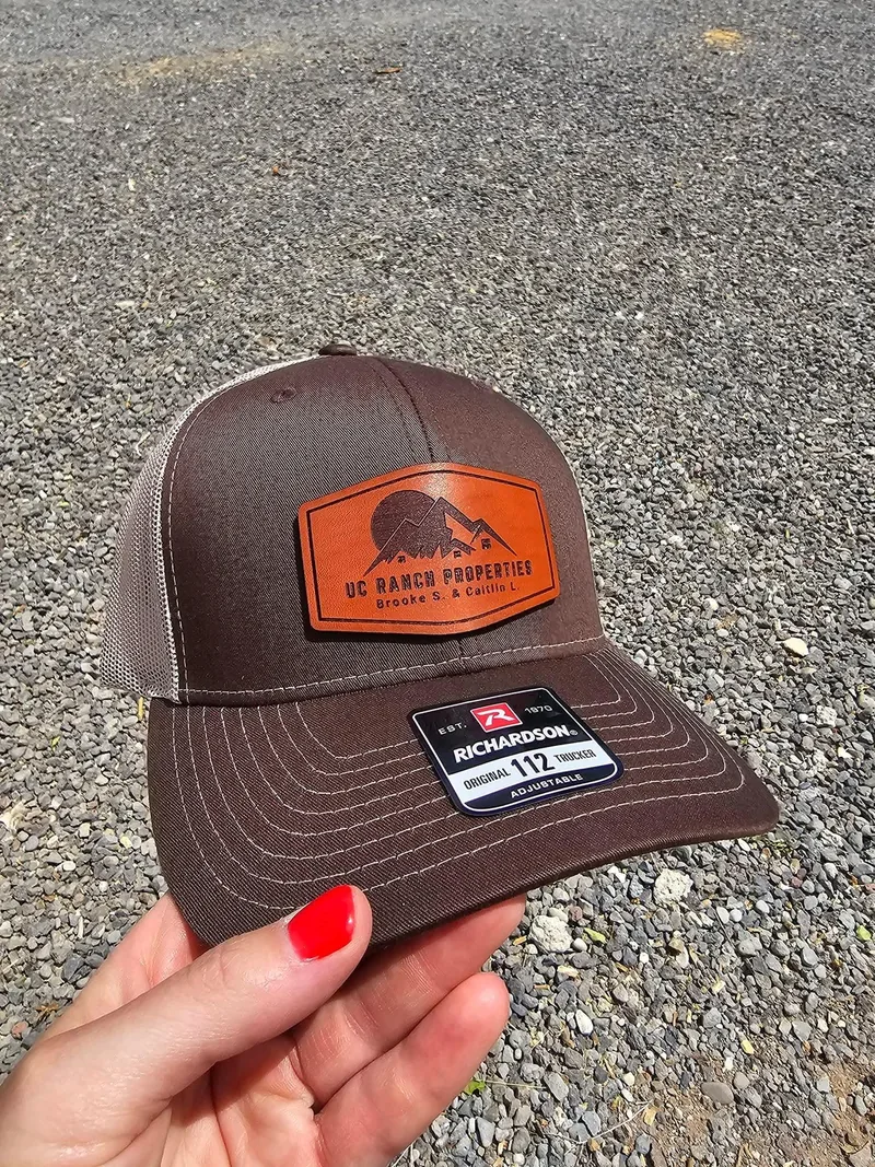 Brown and khaki Richardson 112 with a rust leather UC Ranch Properties patch with mountains and a sun
