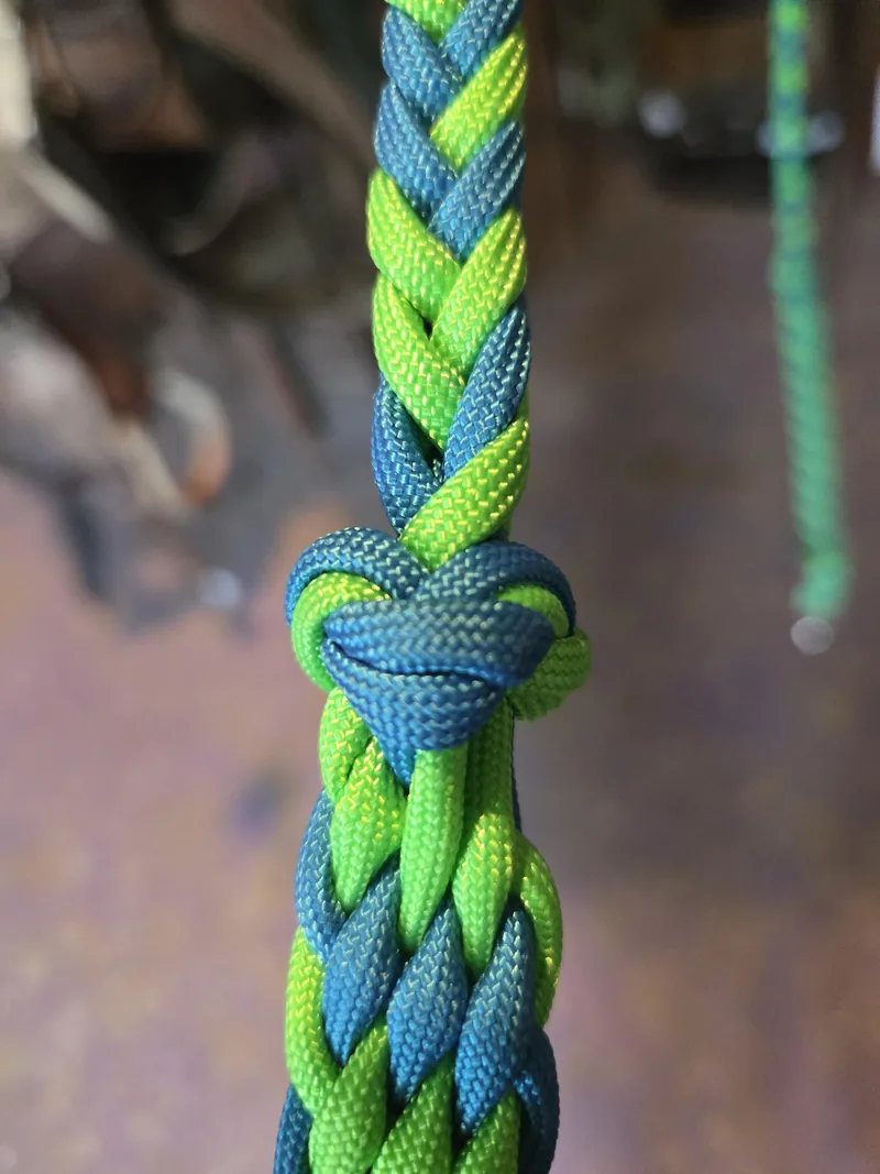 Close-up of a grip knot in a green and blue braid