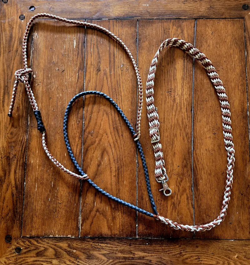 Red Dirt braided tie-down in rust, cream and tan, with a navy section, on a wooden door