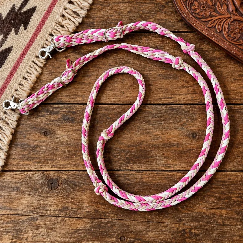 Pink and white braided tie-down on a woven saddle blanket